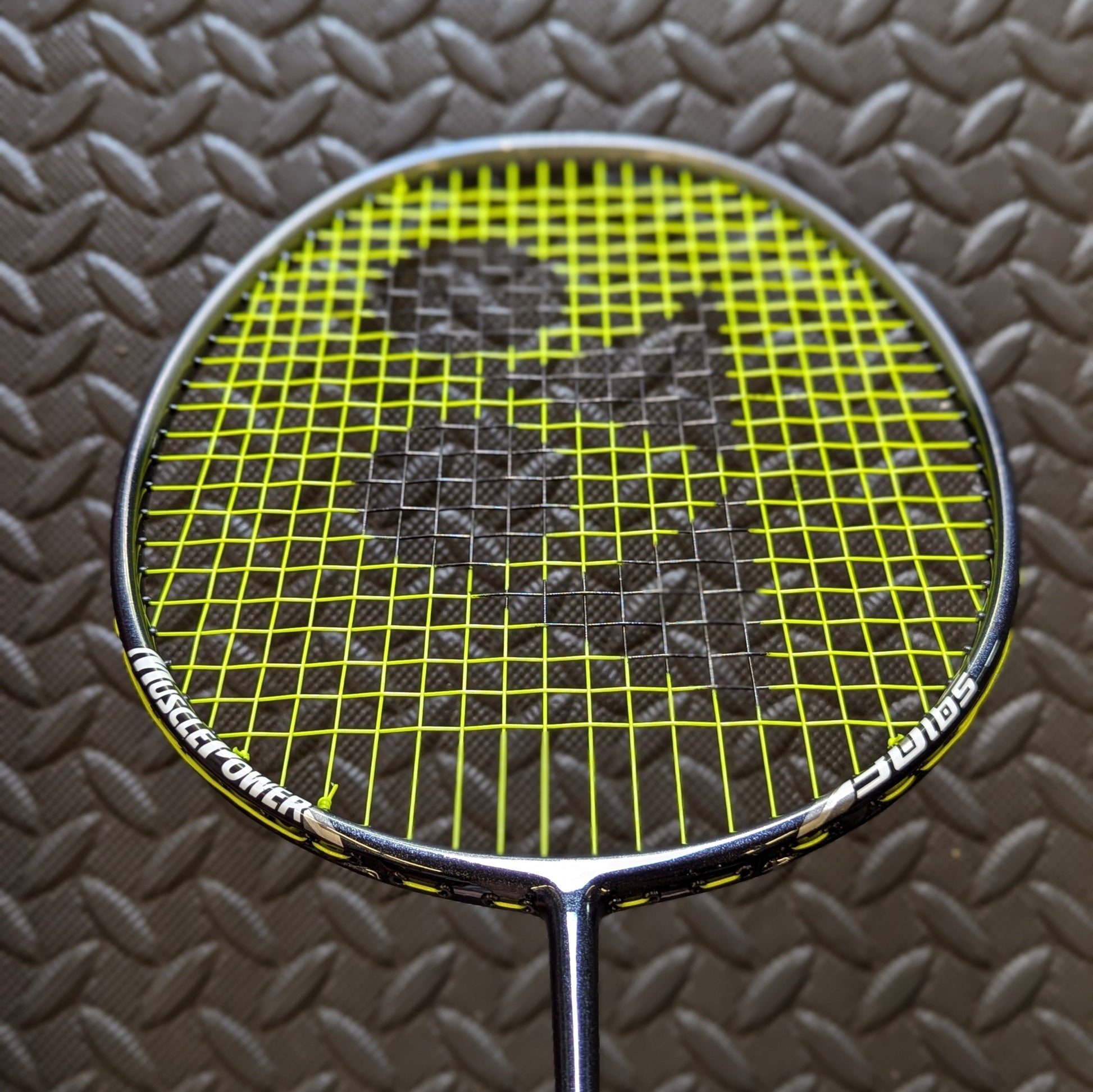 Yonex badminton racket restrung with Yonex BG80 string in yellow with a black stencil