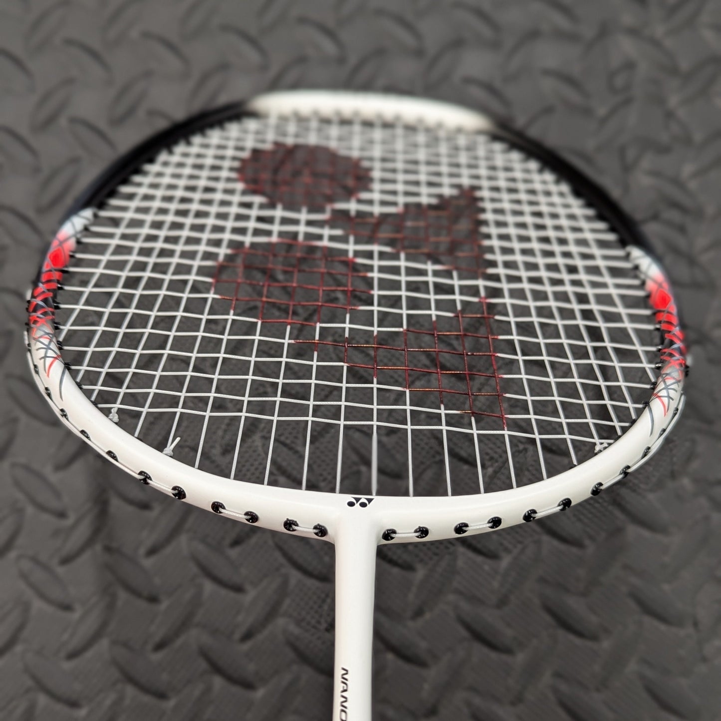 Yonex badminton racket restrung with Yonex BG65 string and red stencil